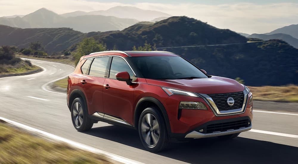 A red 2023 Nissan Rogue is shown from the front at an angle.