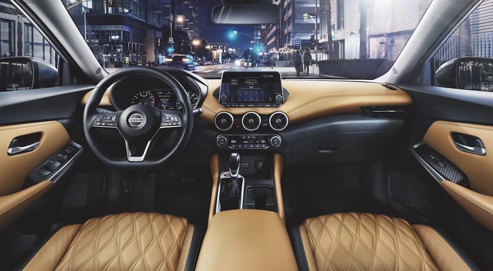 The tan interior of a 2023 Nissan Sentra is shown from above the center console.