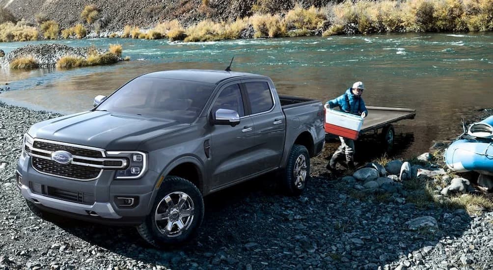 A gray 2024 Ford Ranger Sport 4X4 is shown parked near a river.