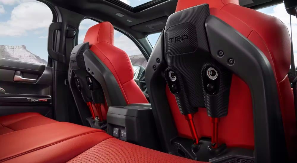 The red and black interior is shown in a 2024 Toyota Tacoma TRD Pro.