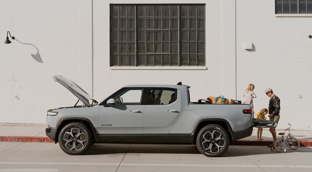 A gray 2023 Rivian R1T is shown parked near a building.