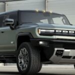 A green 2024 GMC Hummer EV is shown at GMC dealers.