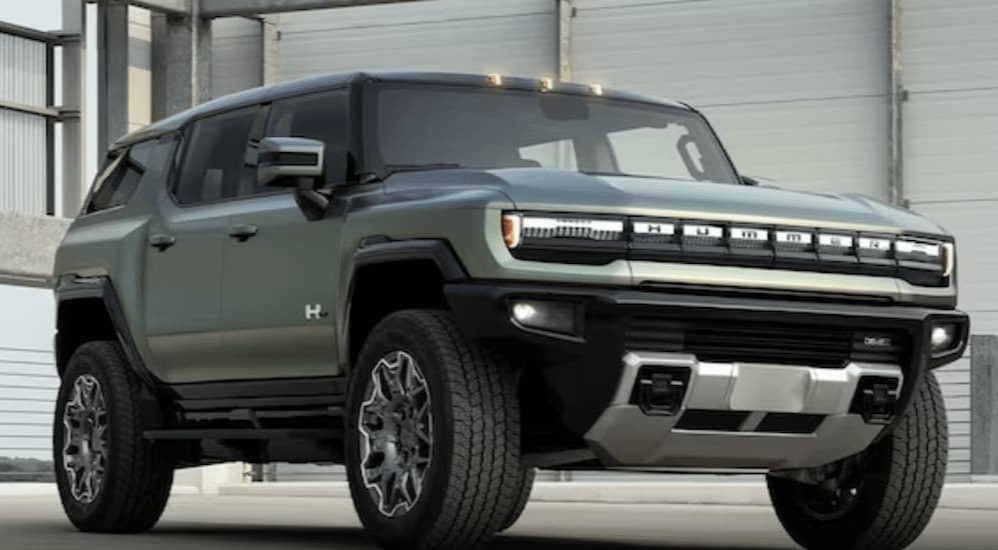 A green 2024 GMC Hummer EV is shown at GMC dealers.