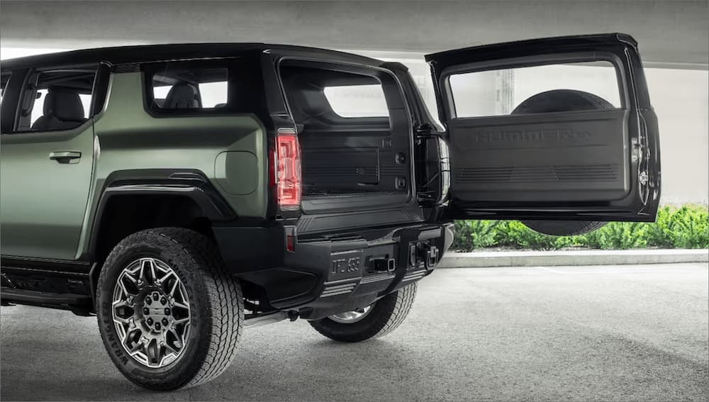 The cargo space of a green 2024 GMC Hummer EV is shown.