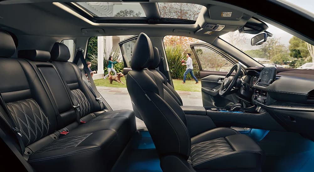 The black interior and dash of a 2023 Nissan Rogue is shown.