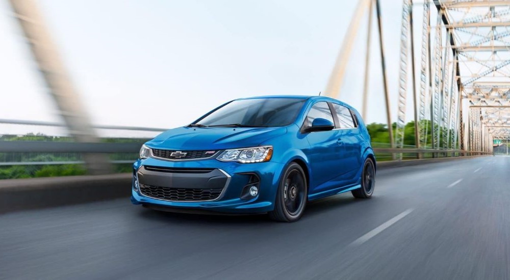 A blue 2020 Chevy Sonic RS is shown on a bridge after looking at used cars for sale.