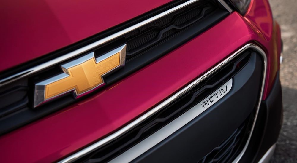 A close up shows the grille on a maroon 2020 Chevy Spark ACTIV.