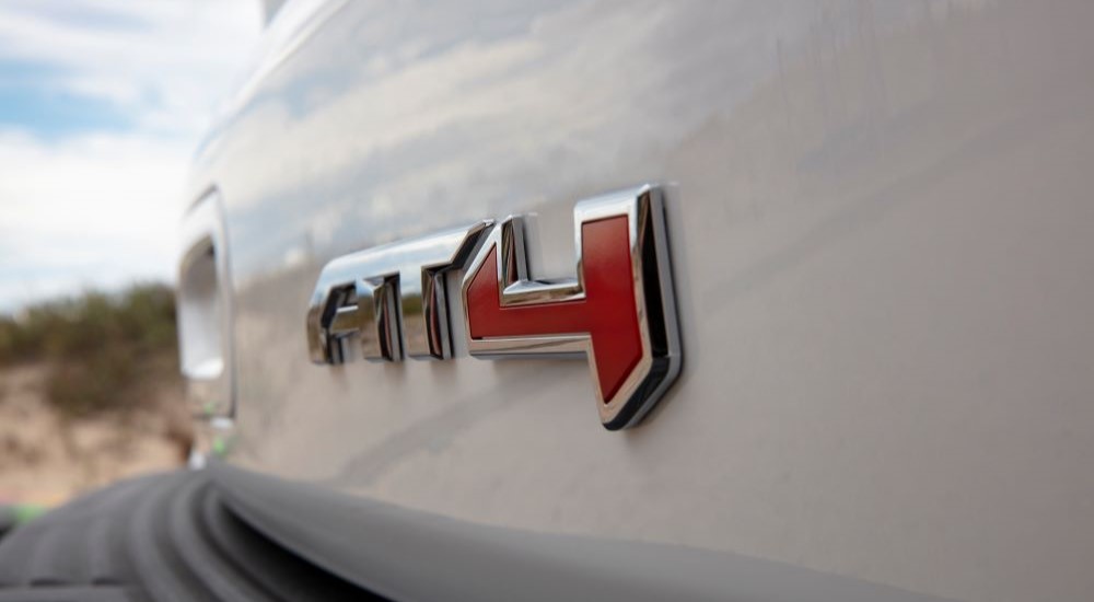 A close up shows the AT4 badge is shown on a white 2021 GMC Yukon AT4.