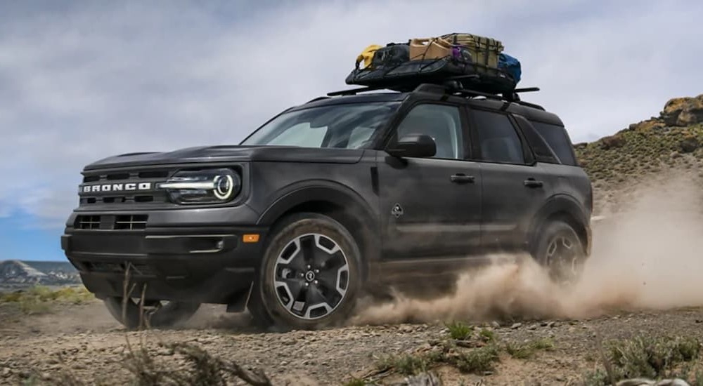 A gray 2021 2021 Ford Bronco Sport is shown driving on the dirt.