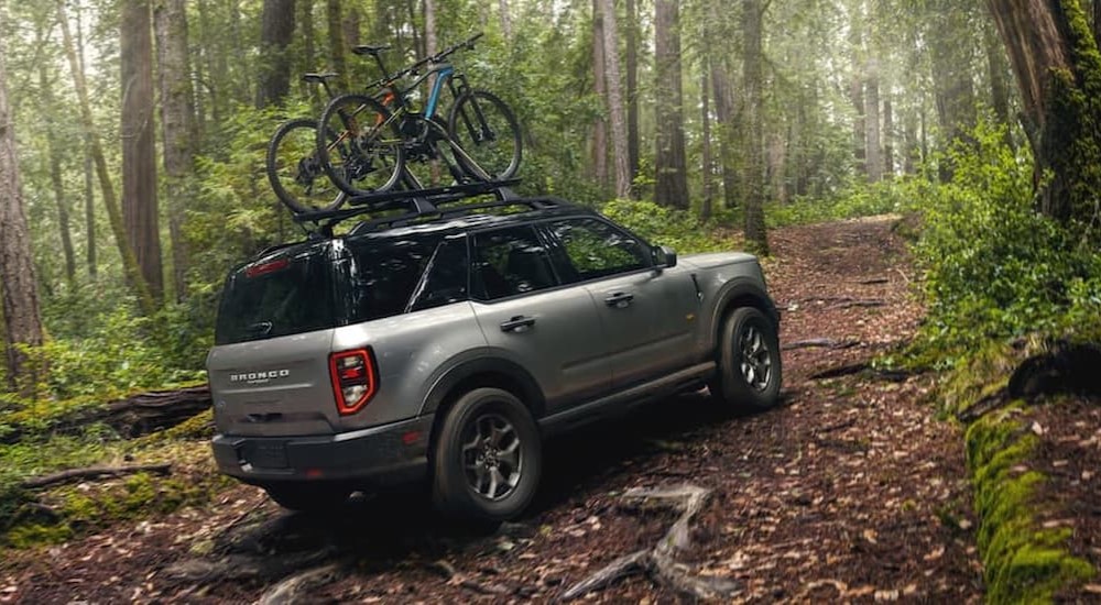 A silver 2021 Ford Bronco Sport is shown driving uphill off-road.