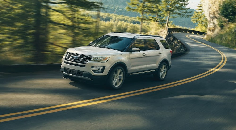 A white 2017 Ford Explorer is shown driving on a highway.