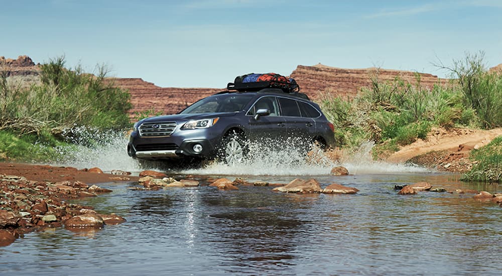 A gray 2017 Subaru Outback is shown driving off-road.