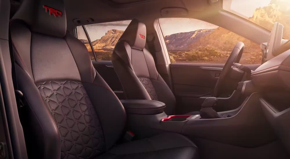 The interior of a 2023 Toyota RAV4 TRD is shown from the passenger side.