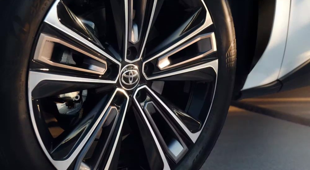 A close up shows the chrome and black wheel on a 2023 Toyota bZ4X Limited.