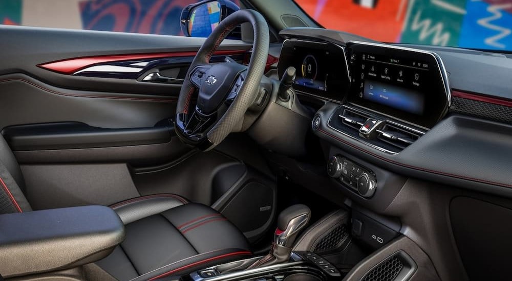 The black and red interior and dash of a 2024 Chevy Trailblazer is shown.