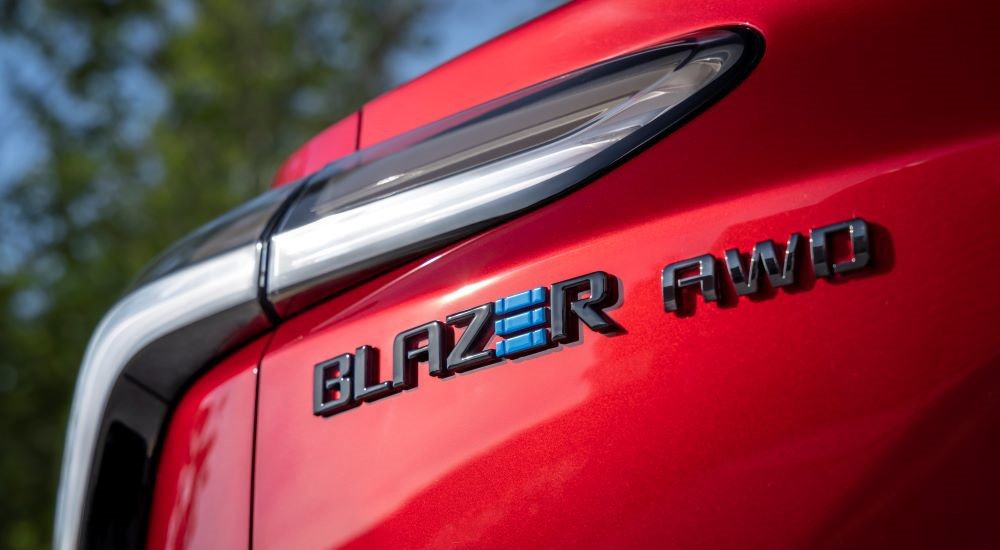 The Blazer AWD badge is shown under the driver side taillight on a red 2024 Chevy Blazer EV.