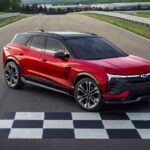 A red 2024 Chevy Blazer EV is shown parked at a finish line.