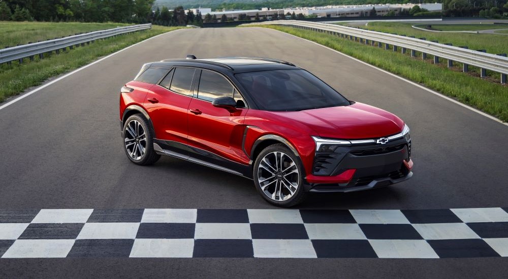 A red 2024 Chevy Blazer EV is shown parked at a finish line.