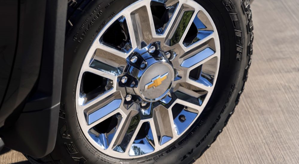 A 2024 Chevy Silverado 2500 HD High Country wheel is shown.