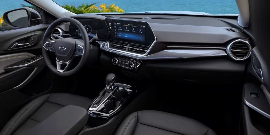 The black interior and dash of a 2024 Chevy Trax is shown.