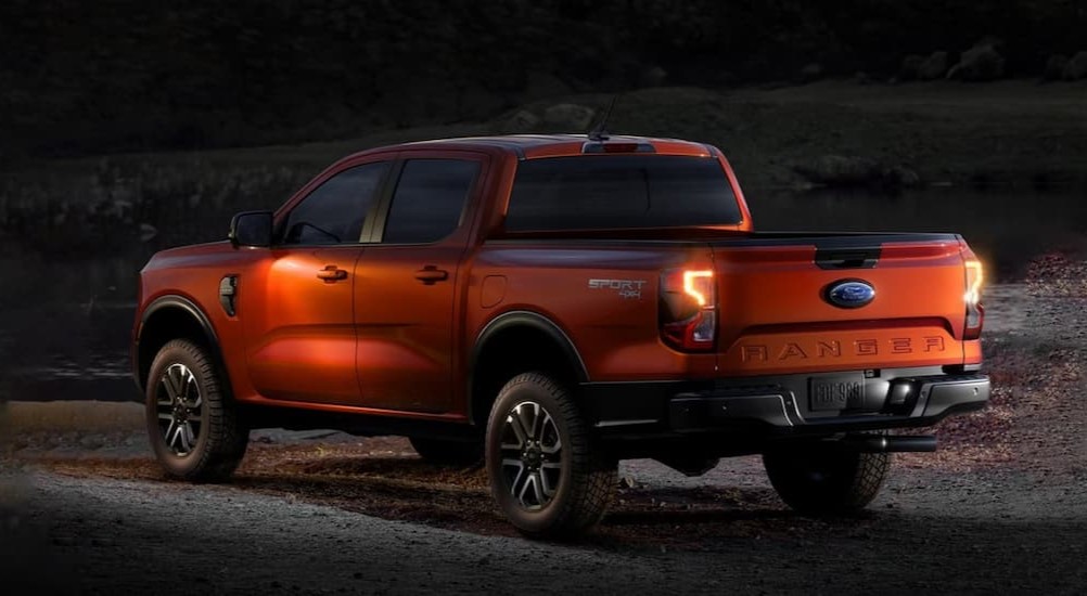 An orange 2024 Ford Ranger Sport 4X4 is shown parked off-road at night.