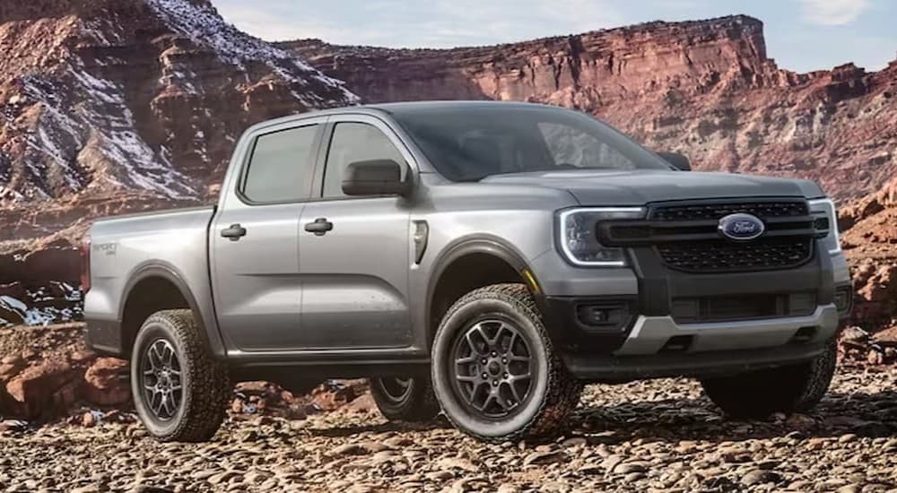 A silver 2024 Ford Ranger is shown parked off-road.
