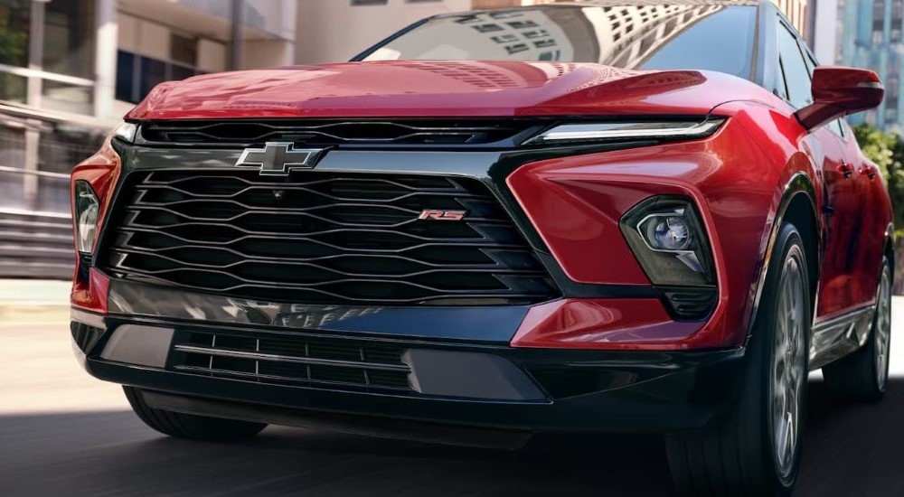 A close up shows the front of a red 2023 Chevy Blazer RS.