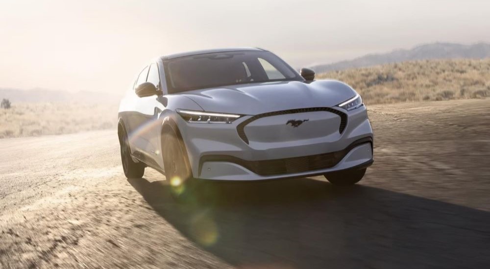 A white 2023 Ford Mustang Mach-E is shown on a sunny day after leaving a Ford dealer near you.