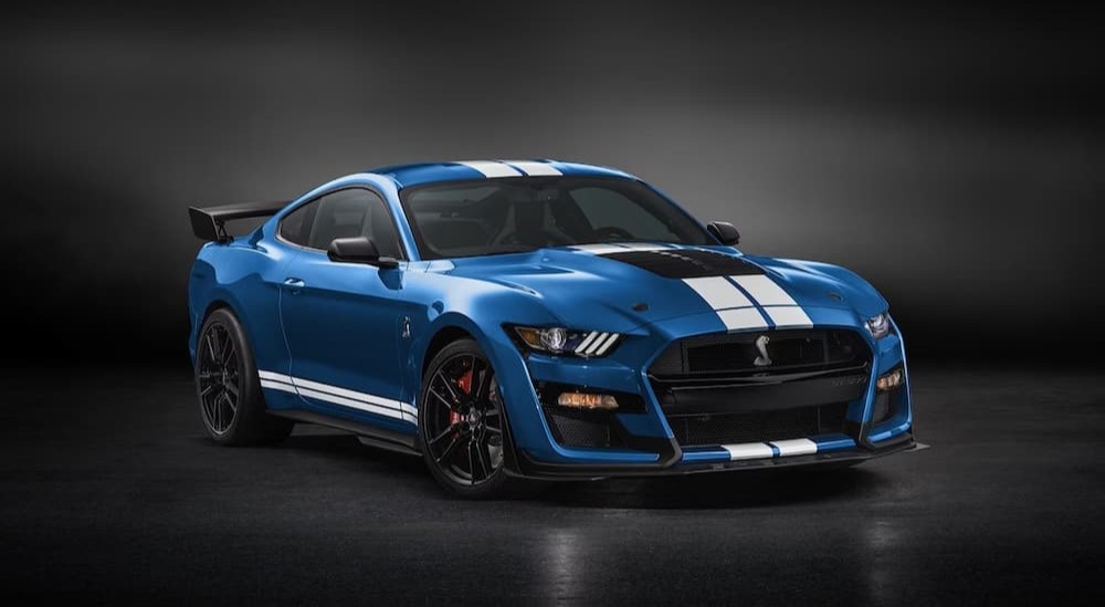 A blue and white 2022 Ford Mustang Shelby GT500 is shown parked in a garage.
