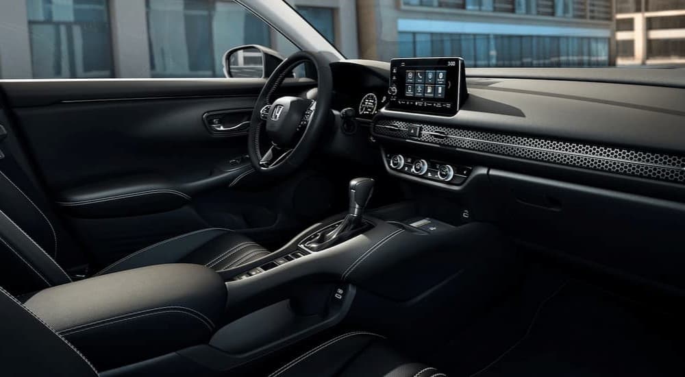 The black interior and dash of a 2023 Honda HR-V EX-L is shown.