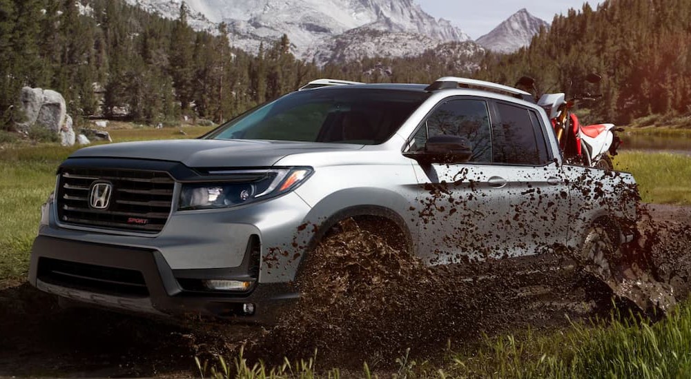 A popular Honda Ridgeline for sale, a silver 2023 Honda Ridgeline, is shown off-roading.