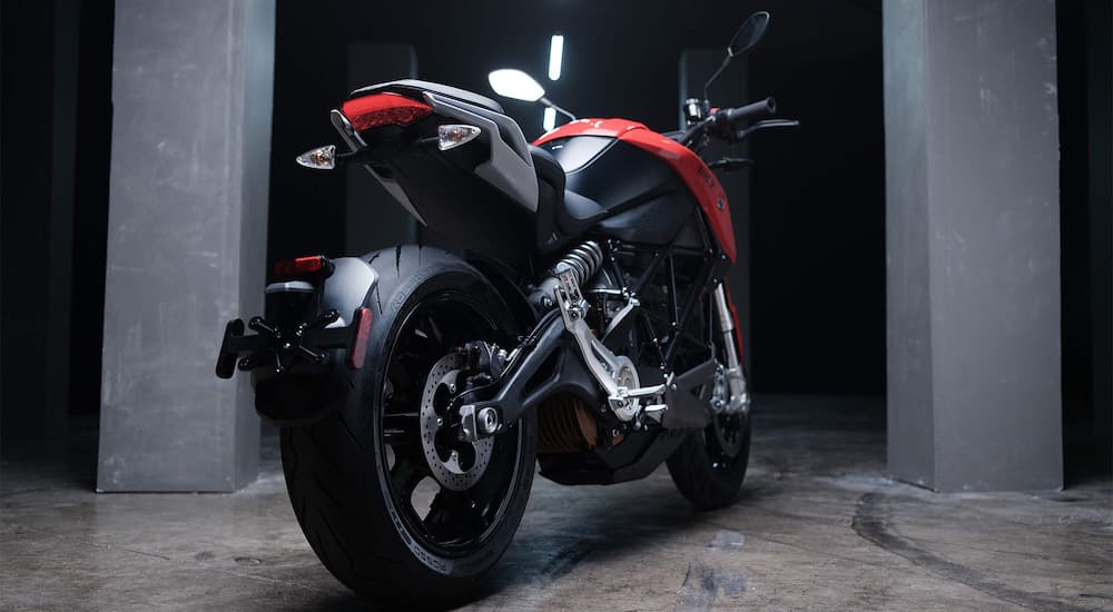 The rear wheel of a red 2023 Zero SR is shown near motorcycle dealers.