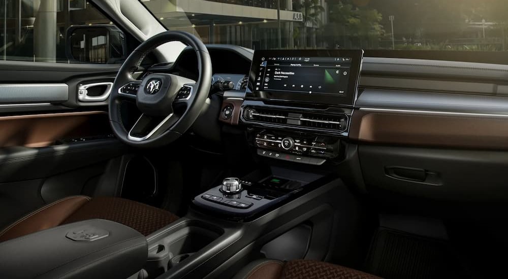 The black and brown interior and dash of a 2024 Ram Rampage is shown.