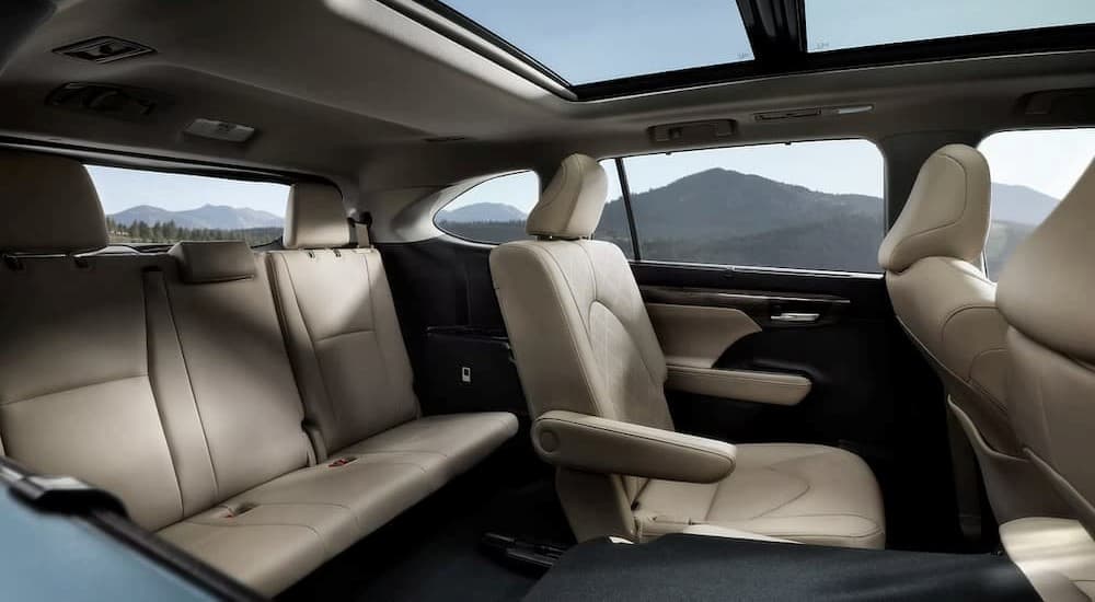 The black and tan interior of a 2023 Toyota Highlander is shown.