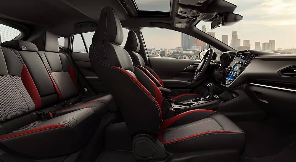 The black and red interior and dash of a 2024 Subaru Impreza is shown.