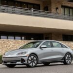 A silver 2024 Hyundai IONIQ 6 is shown parked near a building after viewing electric vehicles for sale.