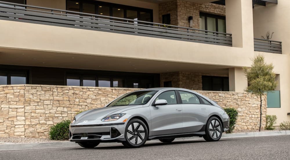 A silver 2024 Hyundai IONIQ 6 is shown parked near a building after viewing electric vehicles for sale.