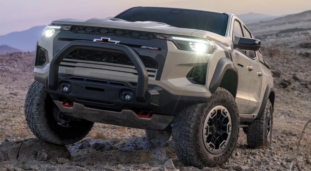 A tan 2023 Chevy Colorado ZR2 is shown parked off-road.