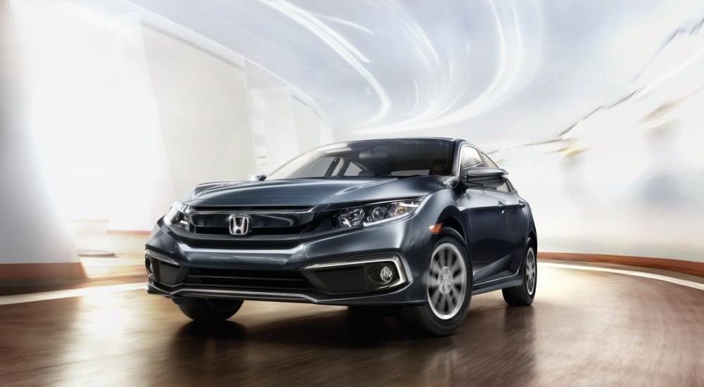 A gray 2019 Honda Civic driving in a bright tunnel.