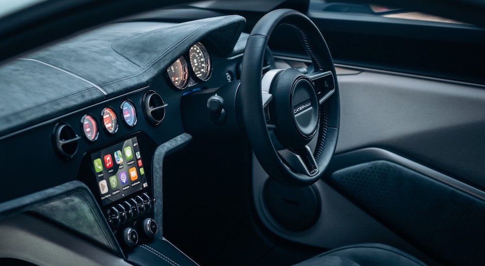 The interior of a 2026 Caterham Project V is shown, including the wheel and gauges.