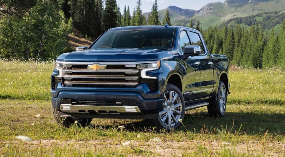 A blue 2023 Chevy Silverado 1500 LTZ is shown parked on grass.