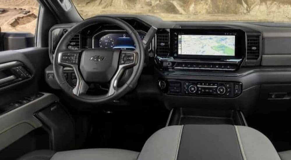 The black and gray interior and dash of a 2023 Chevy Silverado 1500 LTZ is shown. 