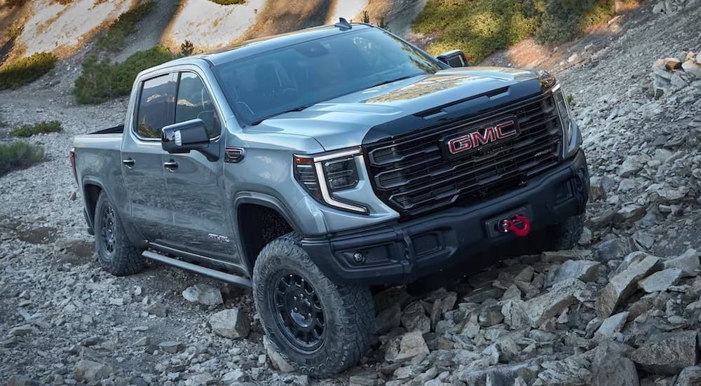 A silver 2023 GMC Sierra 1500 AEV Edition AT4X is shown parked off-road after participating in a 2023 Ford F-150 vs 2023 GMC Sierra 1500 event.