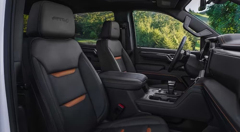 The black and brown interior and dash of a 2023 GMC Sierra 1500 AT4X is shown.