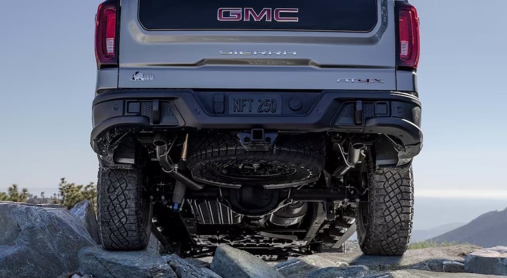 The rear undercarriage of a silver 2023 GMC Sierra 1500 AEV Edition AT4X is shown.