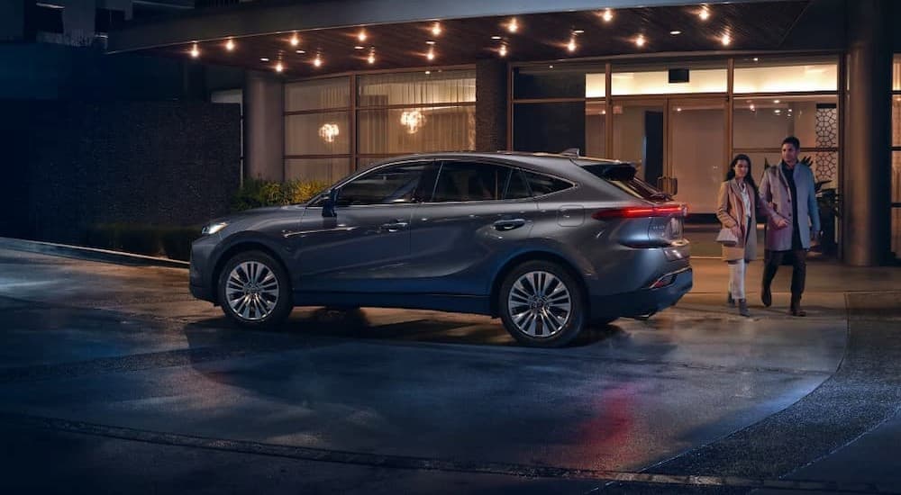 A gray 2023 Toyota Venza is shown parked near a building.