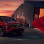 A 2024 Cadillac XT4 for sale is shown parked near a person wearing a red dress.