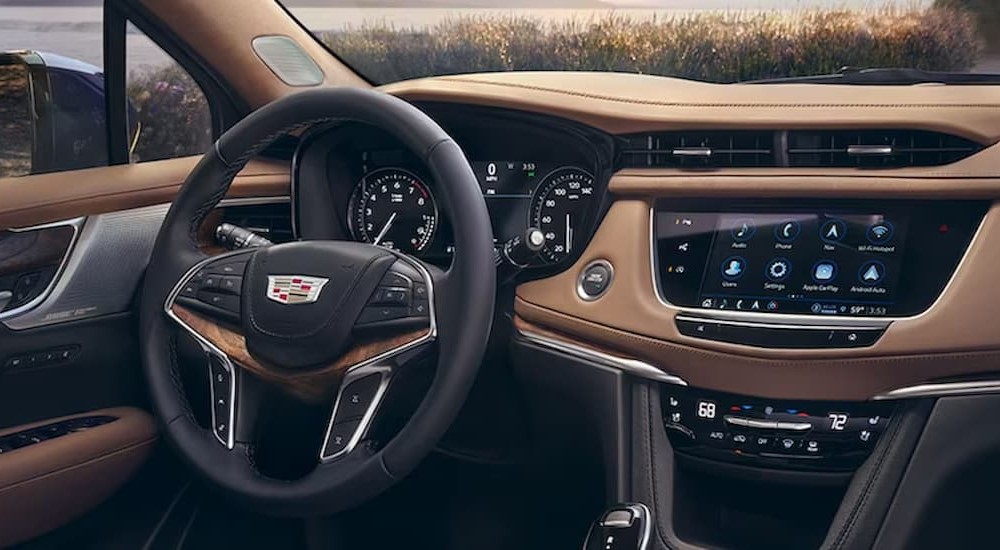 The black and brown dash of a 2024 Cadillac XT5 is shown