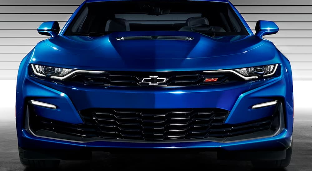 A blue 2024 Chevy Camaro is shown from the front.