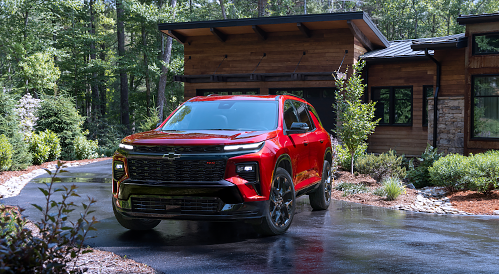 A red 2024 Chevy Traverse is shown parked.